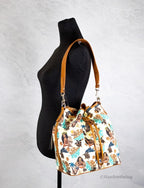 Dooney & Bourke Disney Medium Moana Coated Cotton Bucket Crossbody Bag Purse